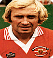 Jimmy Greenhoff wears the 1978 Manchester United Centenary Kit