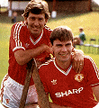 Bryan Robson and new signing Brian McClair show off the United kit worn between 1986 and 1988